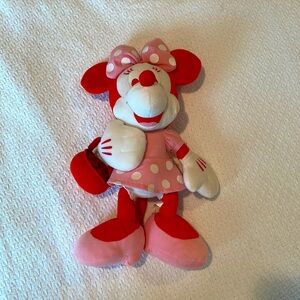 Pink plush Minnie Mouse with strawberry basket.